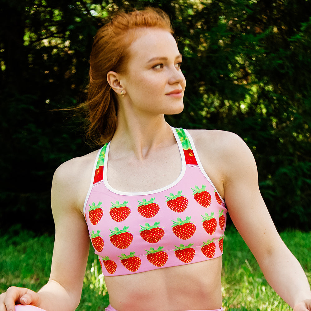 pink strawberry yoga sports bra on woman front