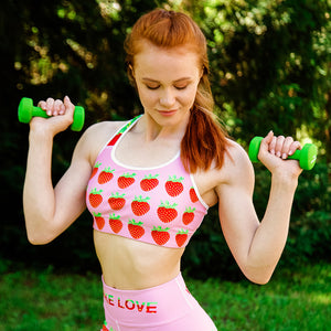 pink strawberry yoga sports bra on woman front